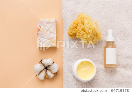 body butter, essential oil, sponge on bath towel body butter, essential oil, sponge on bath towel 64719578