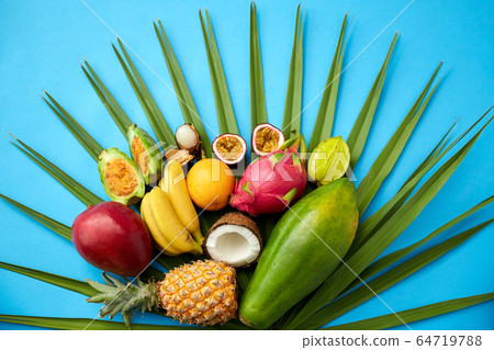 different exotic fruits on blue background 64719788