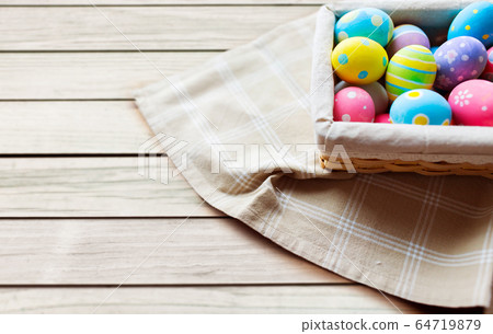 close up of colored easter eggs in basket 64719879