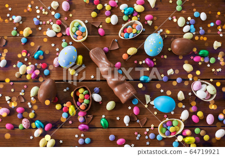 chocolate eggs, easter bunny and candies on wood chocolate eggs, easter bunny and candies on wood 64719921