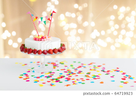 close up of birthday cake with garland on stand 64719923