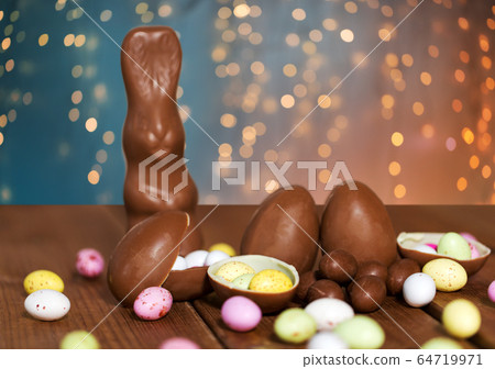 chocolate eggs, easter bunny and candies on wood chocolate eggs, easter bunny and candies on wood 64719971