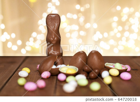 chocolate eggs, easter bunny and candies on wood chocolate eggs, easter bunny and candies on wood 64720018