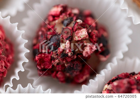 close up of different candies in paper cups 64720305