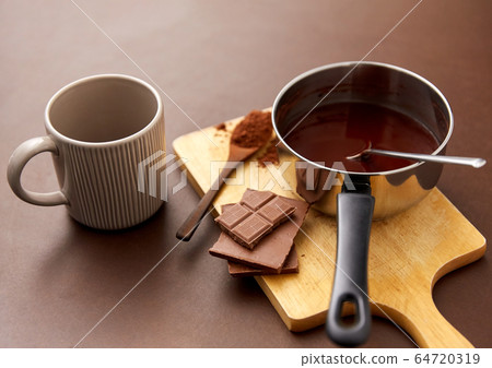 pot with hot chocolate, mug and cocoa powder pot with hot chocolate, mug and cocoa powder 64720319