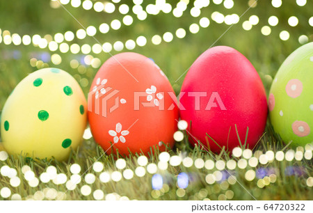 row of colored easter eggs on artificial grass row of colored easter eggs on artificial grass 64720322