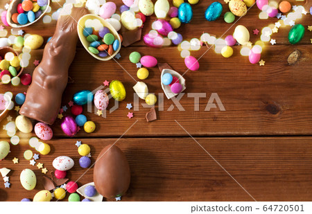 chocolate eggs, easter bunny and candies on wood chocolate eggs, easter bunny and candies on wood 64720501