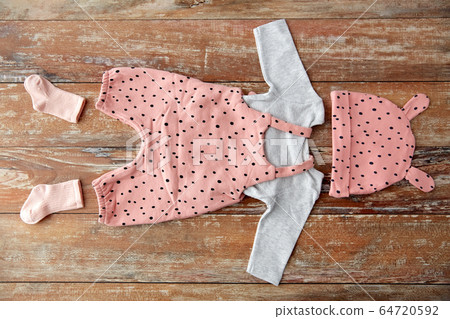 baby clothes set on wooden table baby clothes set on wooden table 64720592