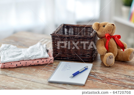 baby clothes, teddy bear, toy blocks and notebook 64720708