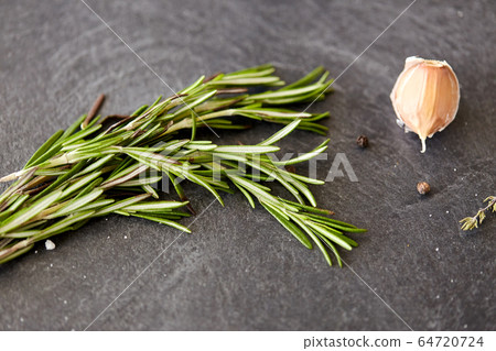 rosemary, garlic and black pepper on stone surface rosemary, garlic and black pepper on stone surface 64720724