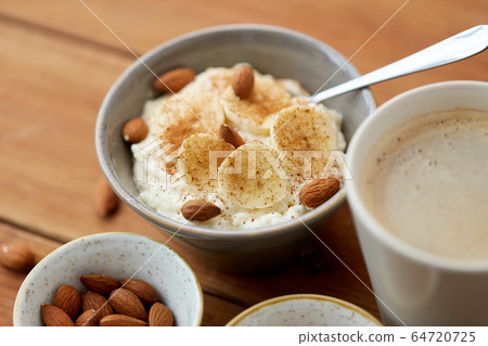oatmeal with banana and almond on wooden table oatmeal with banana and almond on wooden table 64720725