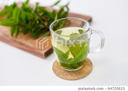herbal tea with fresh peppermint on wooden board 64720815