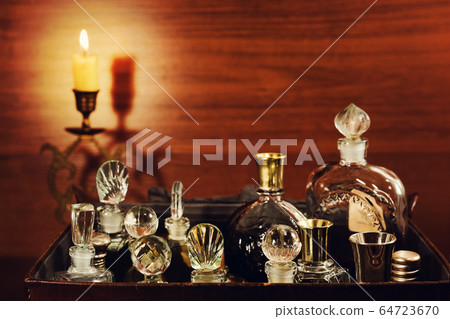 Candlelight and vintage perfume bottles 64723670