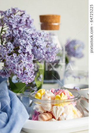 Breakfast with black tea or coffee and sweet meringue kisses on the white table. Breakfast with black tea or coffee and sweet meringue kisses on the white table. 64725225