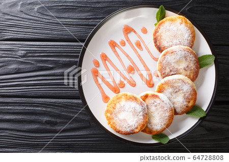 Slavic breakfast syrniki with powdered sugar and Slavic breakfast syrniki with powdered sugar and 64728808