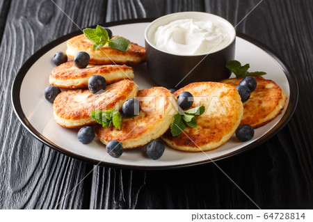 Serving of healthy syrniki served with 64728814