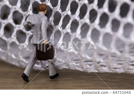 Businessman trying to get out of the mesh 64731048