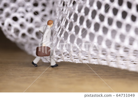 Businessman trying to get out of the mesh 64731049