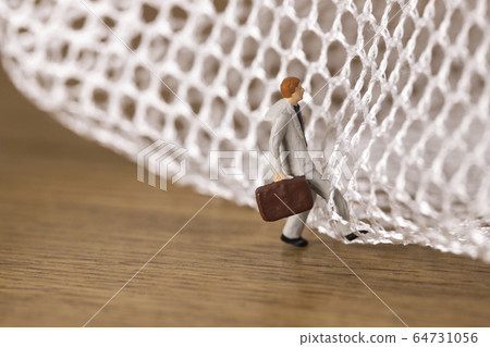 Businessman trying to get out of the mesh 64731056