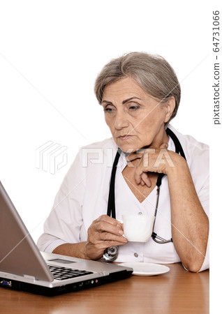 Portrait of confident female doctor sitting at table isolated  64731066