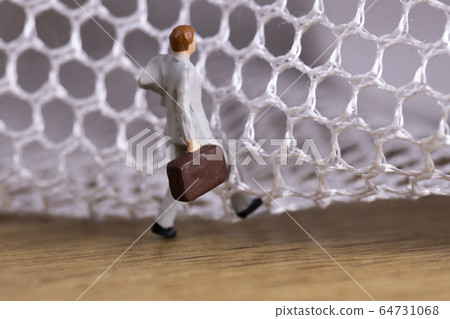 Businessman trying to get out of the mesh 64731068