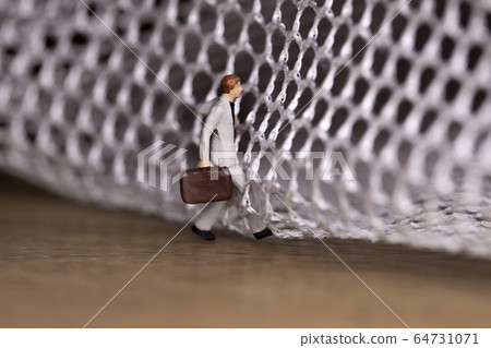Businessman trying to get out of the mesh Businessman trying to get out of the mesh 64731071