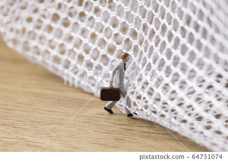 Businessman trying to get out of the mesh 64731074