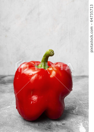 Red bell pepper on grey background Red bell pepper on grey background 64735713
