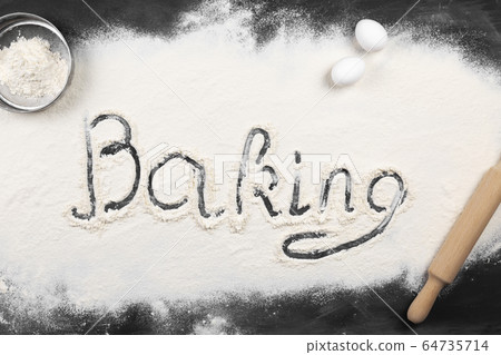 Flour is spread on dark table, inscription baking, Flour is spread on dark table, inscription baking, 64735714