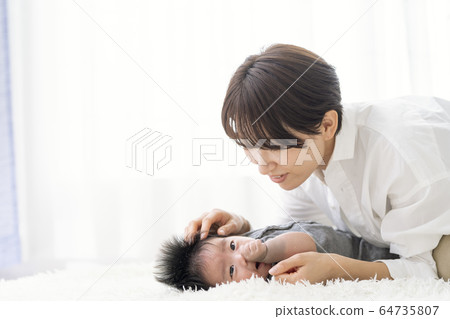 Mother interacting with a three-month-old boy 64735807