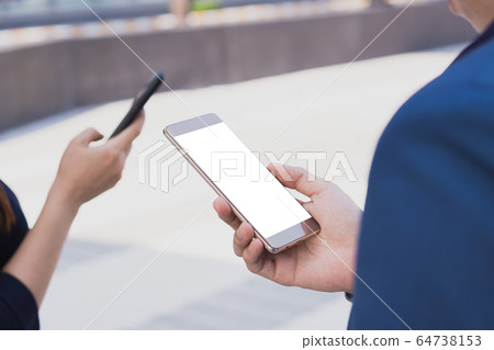 Closeup business man holding smartphone with white Closeup business man holding smartphone with white 64738153