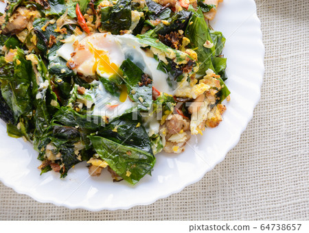 A white plate of delicious Stir-Fried Baegu Leaves A white plate of delicious Stir-Fried Baegu Leaves 64738657
