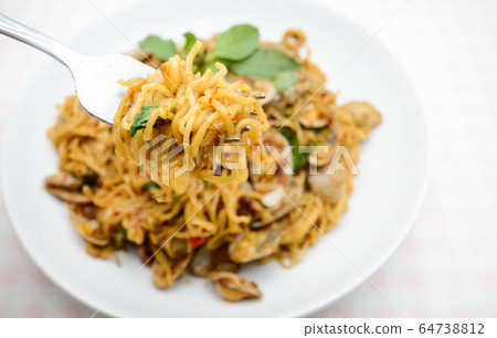 Stir fried noodles with clams and herbs, hot and Stir fried noodles with clams and herbs, hot and 64738812