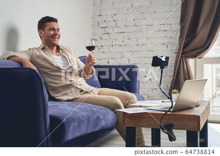 High-spirited Caucasian man enjoying his home party High-spirited Caucasian man enjoying his home party 64738814
