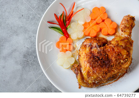 Hot and spicy baked chicken on white plate Hot and spicy baked chicken on white plate 64739277