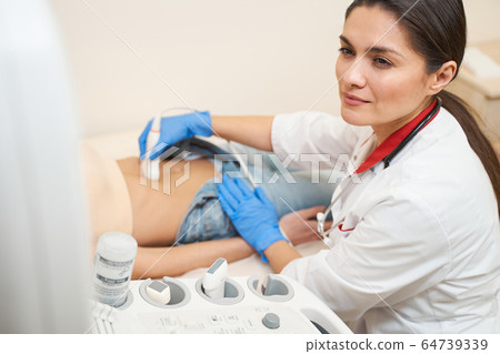 Concentrated young woman looking at screen of computer 64739339