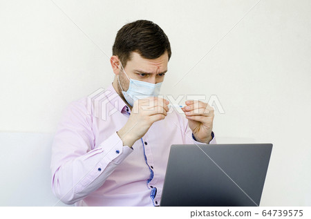 Coronavirus. Quarantine. A man in a shirt measures Coronavirus. Quarantine. A man in a shirt measures 64739575