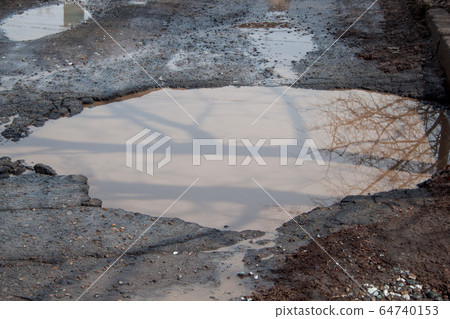 Dangerous destroyed roadbed. Bad asphalted road. 64740153