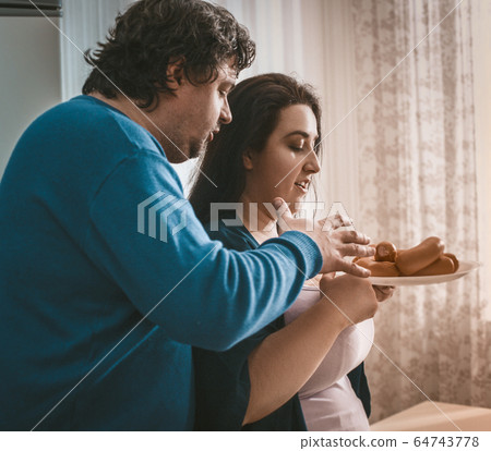 Hungry Overweight Couple Going To Eat Sausages 64743778