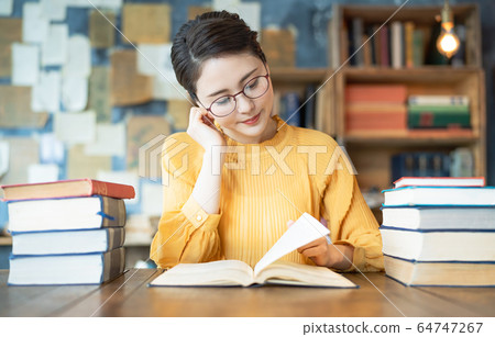 A woman reading a book 64747267