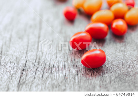 Red cherry tomatoes ceramic bowl on old wooden Red cherry tomatoes ceramic bowl on old wooden 64749014