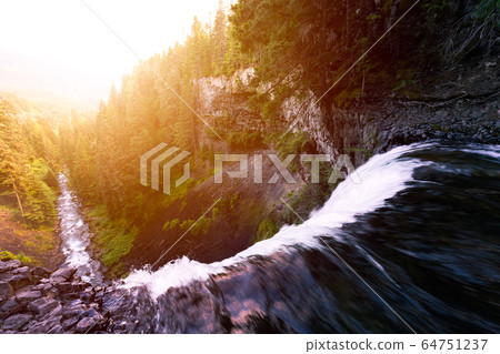 View of the waterfall and the river from the top during a vibrant sunny summer morning 64751237