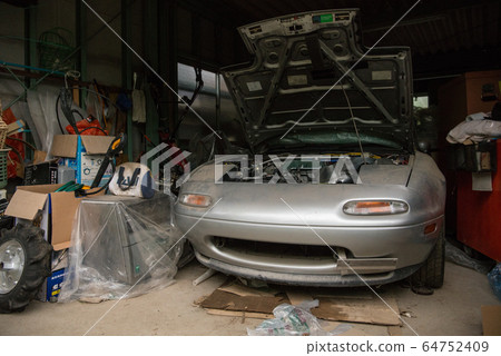 Sports car sleeping in the garage 64752409
