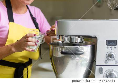 Woman professional pastry chef preparing a 64752814