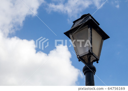 Classic lantern and a blue sky with clouds 64756169
