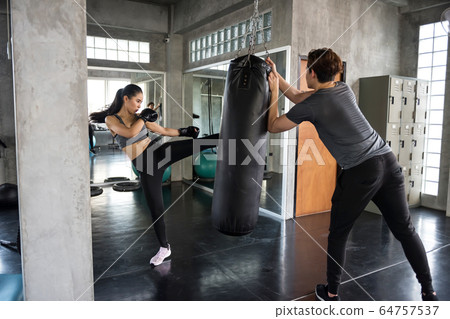 Thai boxing practice with coach in gym Thai boxing practice with coach in gym 64757537