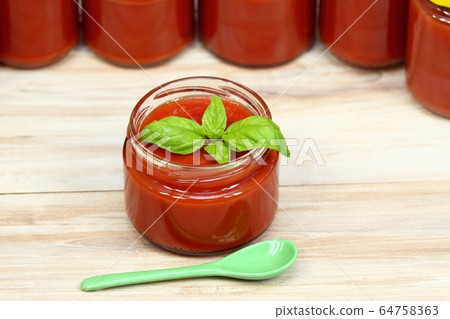 Homemade preserved ketchup and basil leaves Homemade preserved ketchup and basil leaves 64758363