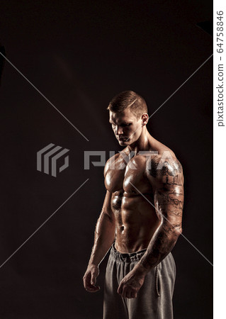 Studio portrait of a shirtless athletic tattooed male Studio portrait of a shirtless athletic tattooed male 64758846