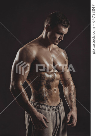 Studio portrait of a shirtless athletic tattooed male Studio portrait of a shirtless athletic tattooed male 64758847