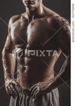 Studio portrait of a shirtless athletic tattooed male 64758848